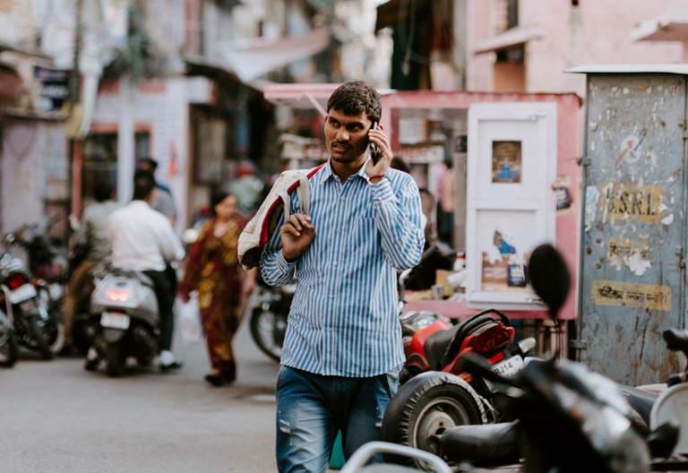 Indian man on phone - landscape. Photo credit: Annie Spratt, Unsplash